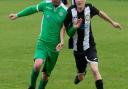 Scott Moore shoulder to shoulder with an opponent during Swaffham Town Reserves' 2-1 defeat at the hands of Holt United Picture: EDDIE DEANE