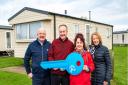 Lucky holiday home winners Mark and Janet Vinnicombe, pictured with Justin Ettridge of Richardson's (left) and Debbie Noye from Archant (right) at Richardson's Hemsby Beach Holiday Park