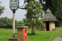 Merton’s village sign and post box, with the thatched bus shelter in the background. Picture: Dr Andrew Tullett
