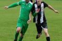 Scott Moore shoulder to shoulder with an opponent during Swaffham Town Reserves' 2-1 defeat at the hands of Holt United Picture: EDDIE DEANE