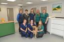 Dereham Vets opens their new premises in the town. Flo Scott director of the practice (back row, centre) with Phoebe, one of her staff's dog