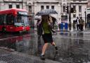 People walking in the rain near Victoria train station, London (Aaron Chown/PA)