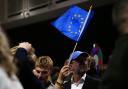 A supporter waves a European Union flag (Marco Di Marco/AP)