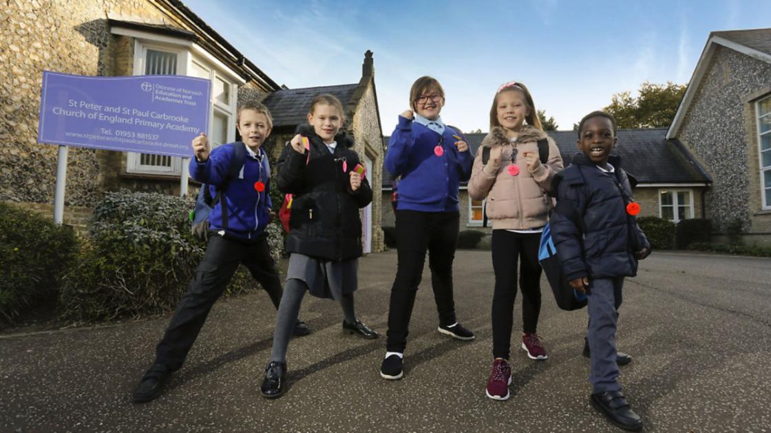 Housing developer donates tags to a Carbrooke school to keep pupils safe when walking 