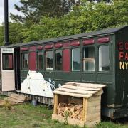 One of the railway carriages you can stay in at Amber's Bell Tent Camping at the Little Massingham Estate.