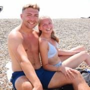 Alice Hardy and her partner, Byron van Uden enjoying the hot weather at Weybourne beach near Holt as a heatwave hits Norfolk.