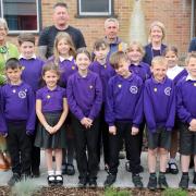 Members of the Swaffham Primary Academy school council celebrate the opening of the school’s Jubilee Garden, with (back row, from left) Joanne Oxborough, school business manager; Maggie Abel, Abel Homes, Ollie Neave, Homecare Landscaping; Richard