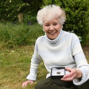 Georgina Rose with the George I coin where she found it in her garden at Caston.