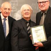 Tributes have been paid to John Marston, who was groundsman at Mundford FC and Mundford CC. Mr Marston (centre) is pictured with Bryan Gunn (right) after winning Groundsman of the Year at Norfolk County FA's volunteer awards. Picture: Norfolk County FA