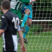 Swaffham Town Reserves keeper Aaron Watson shows a safe pair of hands under pressure from a Beccles Caxton opponent Picture: EDDIE DEANE