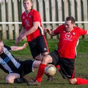 Swaffham Reserves' Aidan Sewell in the  thick of the action during his side's comprehensive home win over Long Stratton Reserves Picture: EDDIE DEANE