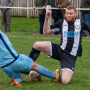 No quarter given as Swaffham Town's Kyle Plumb goes for the ball with a Norwich CBS opponent Picture: EDDIE DEANE