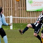 Action from Swaffham Town Reserves' (black and white) 3-2 win over Freethorpe at Shoemakers Lane in Division Three of the Anglian Combination, Billy Russell's attempt to lob the keeper. Picture: Eddie Deane