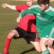 Action from Watton United's CS Morley Cup semi-final against Long Stratton Reserves (red).