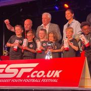 Players and coaches from Hockering FC Boys under seven being presented by Kevin Keegan and England women's legend Rachel Unitt with their trophies after winning ESF Festival of Football in their age division