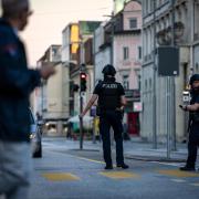 Police officers patrol a street in downtown Aarau (Michael Buholzer/Keystone via AP)
