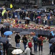 Flowers and cards are laid at the Blue Stone in Bergen (Silje Katrine Robinson /NTB Scanpix/AP)